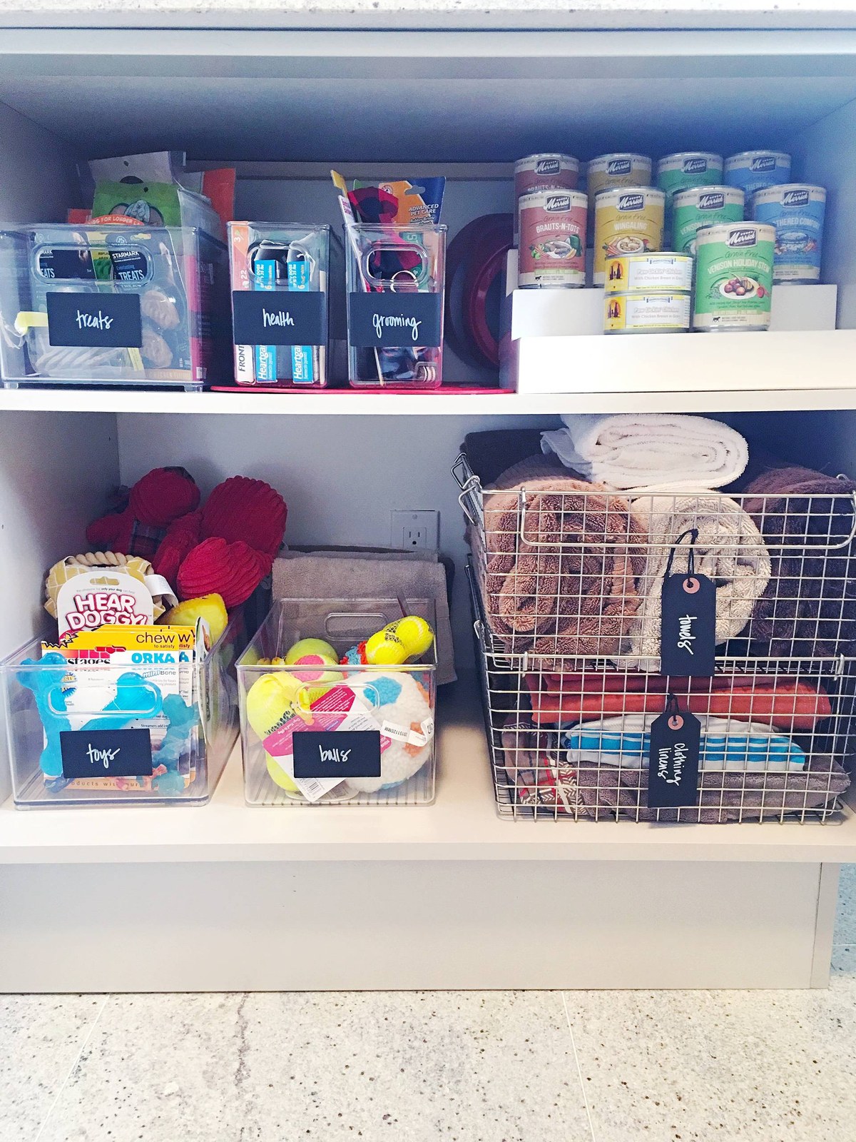 Chalkboard labels on bins holding dog treats, grooming supplies, and toys